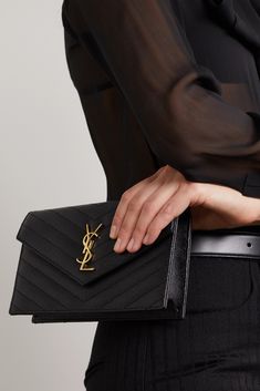 SAINT LAURENT's sleek 'Cassandre' wallet comes with a detachable chain strap, so it can be worn as a clutch depending on the occasion. It's crafted from durable textured-leather with a matelassé finish and topped with a 'YSL' logo plaque. The interior is fitted with six card slots, a bill sleeve and a zipped compartment that's perfect for storing your lipstick and keys. Ysl Bag Clutch, Ysl Small Envelope Wallet, Ysl Envelope Medium Bag, Ysl Envelope Bag Black, Leather Envelope Wallet On Chain, Luxury Business Clutch Wallet On Chain, Luxury Business Wallet On Chain Clutch, Classic Envelope Wallet On Chain For Evening, Designer Wallet On Chain For Everyday Luxury