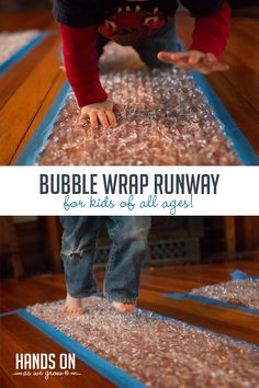 a child playing with bubble wrap on the floor