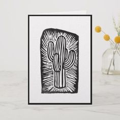 a card with a black and white drawing of a cactus