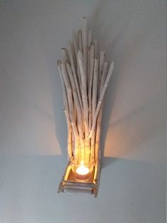 a light that is sitting on top of a wooden chair with sticks sticking out of it