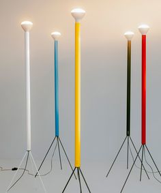 four different colored lamps are standing in a row