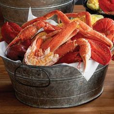 two buckets filled with cooked lobster and corn