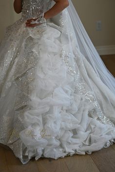 a woman in a white wedding dress is posing for the camera