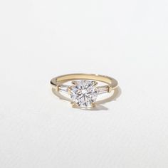 a yellow gold engagement ring with a single diamond