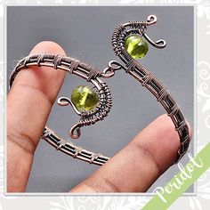 Peridot Quartz Eclectic Copper Wire Wrapped Artisan Cuff Bangle (Lime Green) Style: Boho, Gypsy, Bollywood, Ethnic, Festival, Hippie, Artisan, Handcrafted, Handmade Metal: Plated Copper Features: Wire Wrapped Bracelet Design With Scrolls & Three-Tiered Woven Band Main Stone: Peridot Quartz, Rounded (Lime Green) Created In / Purchased From: Jaipur, India Size: Adjustable From My Worldwide Collection Of New & Vintage Eclectic, Boho Treasures. Favorites Include Designs From Israel, India & Native Americans. Been Collecting For Decades, More To Come! U-9684 Wire Wrapped Cuff Bracelet, Wire Wrap Bracelet, Wire Wrapped Bangles, Wire Wrap Jewelry Designs, Nugget Bracelet, Eclectic Boho, Blue Beaded Bracelets, Open Cuff Bracelet, Wire Jewelry Designs