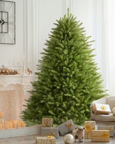 a christmas tree is surrounded by presents and candles