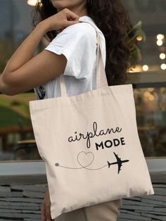 "Airplane Mode Tote Bag is a perfect bag for your everyday life. This practical and environmentally friendly tote bag is great to take with you on your travels, because it packs very small and is super lightweight. Canvas tote bag is definitely a gift idea that you can't go wrong with! ✅  PRACTICAL & REUSABLE - This unique reusable bag is convenient, portable, and perfect for shopping, holding groceries, ideal for school and work, and makes a simple lightweight day bag ✅  PERFECT GIFT - Makes a Trendy Bag With Luggage Sleeve, Trendy Bag With Luggage Sleeve As Gift, Flight Attendant Gifts, Tote Aesthetic, Airplane Gifts, Canvas Bag Design, Linen Tote Bag, Fabric Painting On Clothes, Bag Quotes