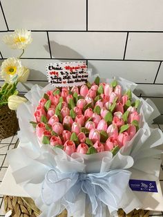 a bouquet of pink tulips on a table