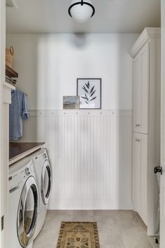 a washer and dryer in a white laundry room