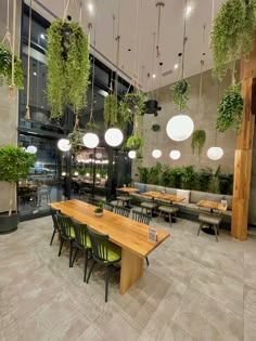 an indoor dining area with tables and hanging plants