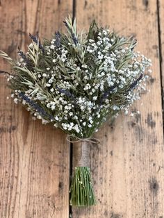 a bouquet of flowers sitting on top of a wooden table