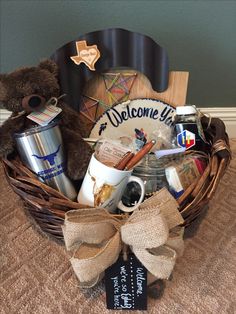 a teddy bear sitting in a basket filled with coffee and other personal care items on a table