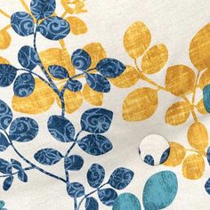 the fabric has blue, yellow and white flowers on it with circles in front of them