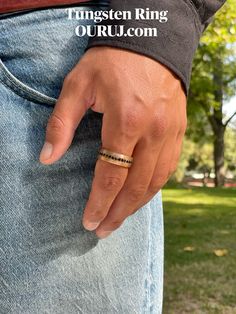 a man wearing a ring on his left hand with the words ringsten ring our uj com