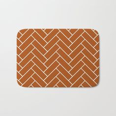 an orange bath mat with white lines on it