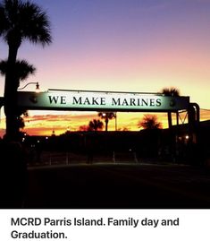 we make marines sign in front of palm trees at sunset with the sun setting behind it