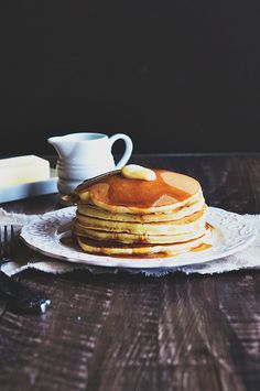 a stack of pancakes sitting on top of a white plate