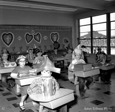 an old black and white photo of children in school