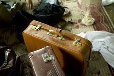 three pieces of luggage sitting on the floor