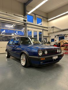 a blue car is parked in a garage