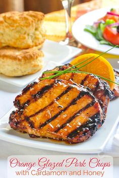 orange glazed pork chops with cardamon and honey on a white platter