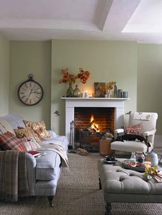 a living room filled with furniture and a fire place in the middle of the room