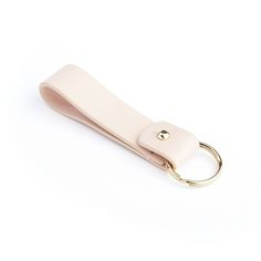 a pink leather keychain with a gold ring