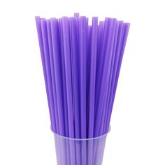 purple paper straws in a plastic cup on a white background