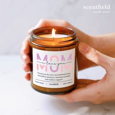 a person holding a candle in their hand that says mom leave your mom on it