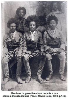 an old black and white photo of men sitting on a bench with baskets in their hands