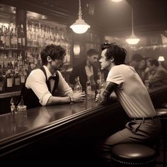 two men sitting at a bar talking to each other