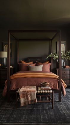 a four poster bed with pillows and blankets on it