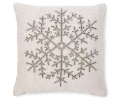 a white pillow with snowflakes on it