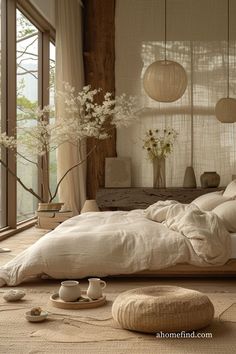 a large bed sitting in the middle of a bedroom next to a tall glass window