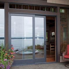 a red chair sitting in front of a glass door