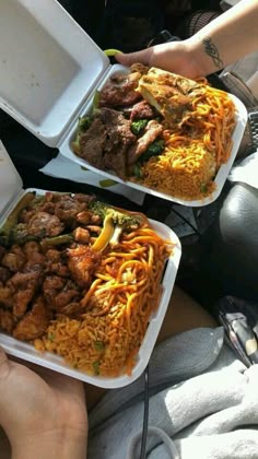 two people holding up plates of food with meat and veggies on them in their hands