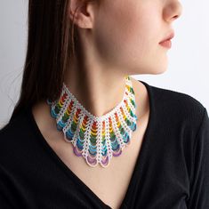 a woman wearing a multicolored crochet necklace