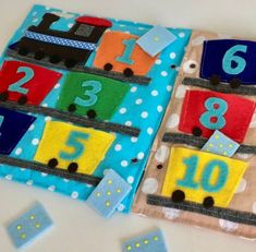 two pieces of fabric with numbers and trains on them, sitting next to each other