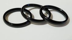 three black rings sitting on top of a white table