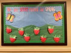 a bulletin board with strawberries and butterflies on it