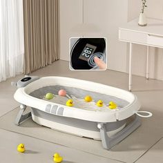 a child's bathtub with ducks in it and an alarm clock on the wall