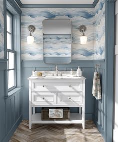 a bathroom with blue and white wallpaper, two sinks and a mirror on the wall