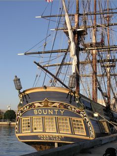 an old sailing ship is docked at the dock