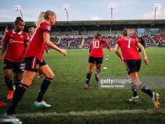 the women's soccer team is playing against each other in front of an empty stadium