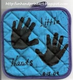 a blue pot holder with black handprints on it and the words, little hands