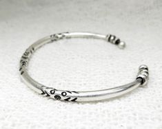 ❋ Handmade Sterling Silver Adjustable Rounded Engraved Solid Cuff Bracelet with Beads, Ethnic Tribal Design Can be as a set or single ❋ Adjustable ❋ Metal Purity: 95% Silver (higher than sterling Silver - 92.5%) To browse some more of our Silver Jewelry collection you can click on the following links: https://www.etsy.com/shop/SilverShapes Earrings: https://www.etsy.com/shop/SilverShapes?section_id=14809462&ref=shopsection_leftnav_1 Rings: https://www.etsy.com/shop/SilverShapes?section_id=14 Artisan Adjustable Bangle For Festivals, Traditional Adjustable Nickel-free Bangle, Bohemian Bangle With Silver Beads As A Gift, Bohemian Bangle With Silver Beads For Gift, Nickel-free Adjustable Traditional Cuff Bracelet, Bracelet With Beads, Silver Engraving, Silver Cuff Bracelet, Handmade Boho