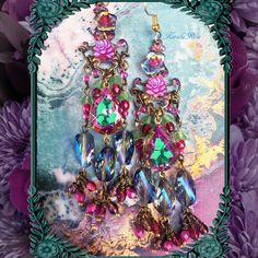 "This pair of Handmade Chandelier Earrings is made with Vitrial Rose teardrop jewels and sparkly Blue helix crystal beads.  Fuchsia AB Czech glass roses and hand-wrapped bead charms add loads of colorful detail. They're a delicate fantasy design with a pretty sparkle! The teardrop jewels are a vibrant Mint Green with Magenta edging.  Pierced with french wires  clip-ons or posts, just select from the pull-down menu.  Choose from the long or short version.  The short is seen in the last 2 images. Jeweled Dangle Chandelier Earrings, Crystal Jeweled Chandelier Earrings Gift, Bohemian Jeweled Chandelier Earrings As Gift, Jeweled Dangle Chandelier Earrings As Gift, Jeweled Chandelier Dangle Earrings For Celebration, Pink Jeweled Dangle Chandelier Earrings, Bohemian Jeweled Crystal Dangle Earrings, Bohemian Jeweled Dangle Chandelier Earrings, Bohemian Crystal Chandelier Drop Earrings