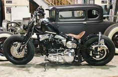 a motorcycle parked next to an old car