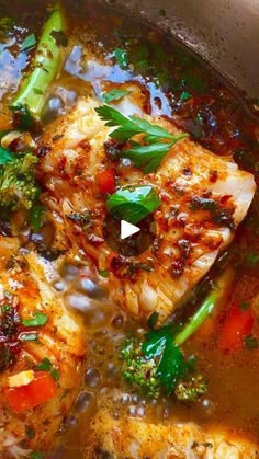 some fish and vegetables are cooking in a pot