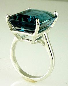 ALL OUR JEWELRY IS HANDCRAFTED IN THE U.S.A. Lovely as the clear, radiant blue of island seas... This exquisitely emerald cut London Blue Topaz is of rare great size not seen in a London Blue Topaz a full 27.45 carats-- catching the light and dazzling your friends. This ring is sure to capture the attention of many admiring glances. And this great traditional design of the setting perfectly complements this great stone. Set in solid .925 sterling silver. You will love it... London Blue Topaz, (1 Formal Blue Topaz Octagon Rings, Formal Octagon Blue Topaz Rings, Modern Formal Hallmarked Topaz Ring, Formal Aquamarine Topaz Ring With Bezel Setting, Modern Blue Topaz Ring For Formal Occasions, Formal Emerald Cut Topaz Ring With Bezel Setting, Formal Emerald-cut Topaz Ring With Bezel Setting, Formal Octagon Sapphire Solitaire Ring, Formal Octagon Solitaire Sapphire Ring